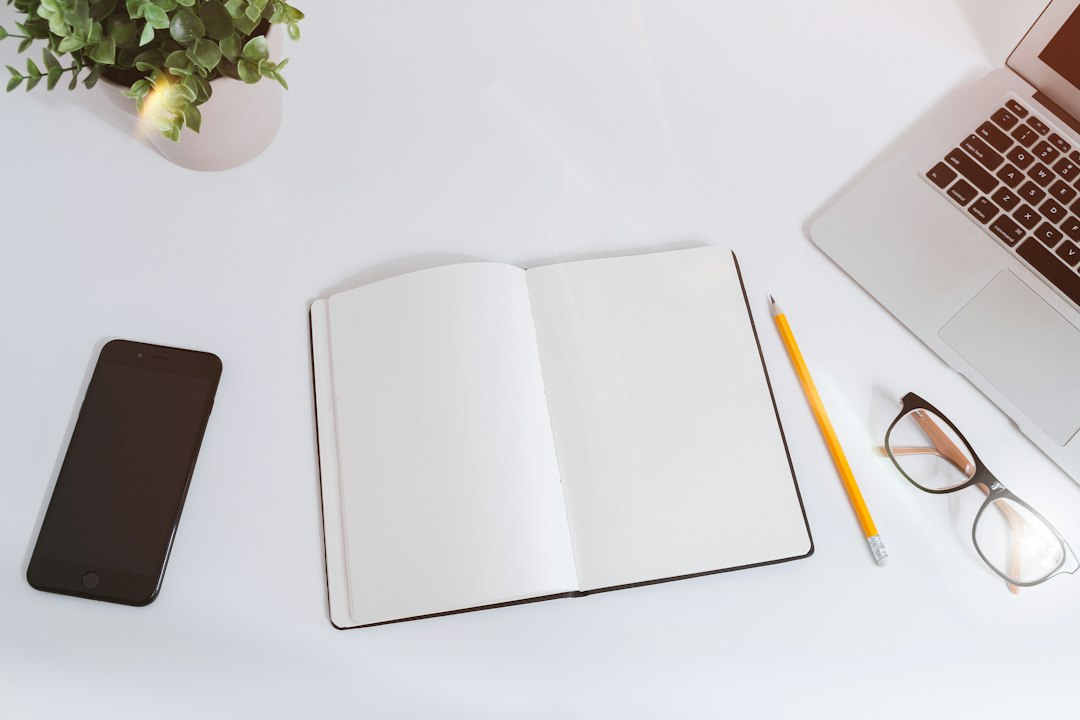 Notebook, smartphone and laptop arranged on a clean desk for planning and mental clarity