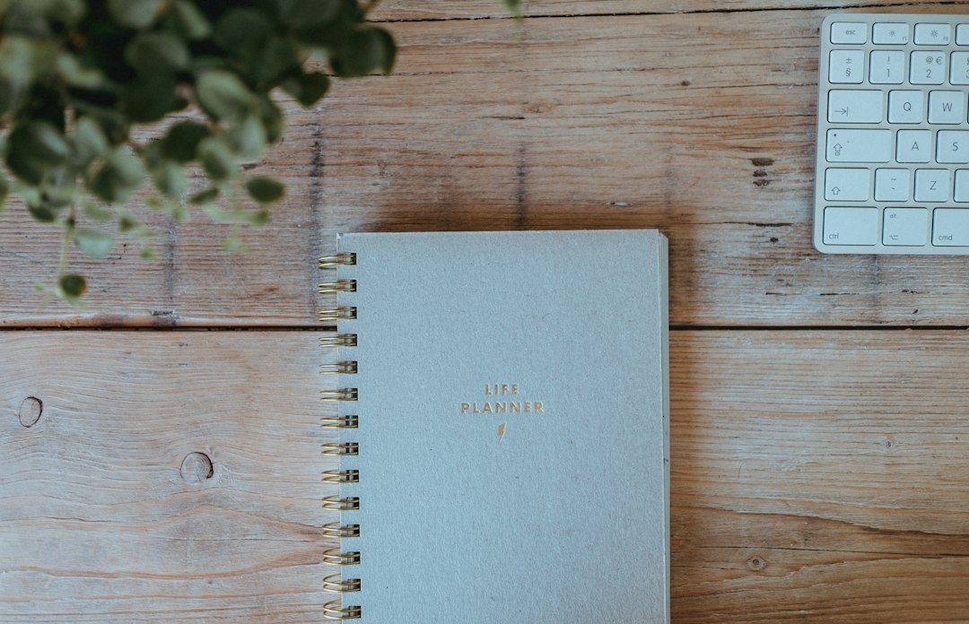 Open planner beside a smartphone representing a weekly reset and intentional planning