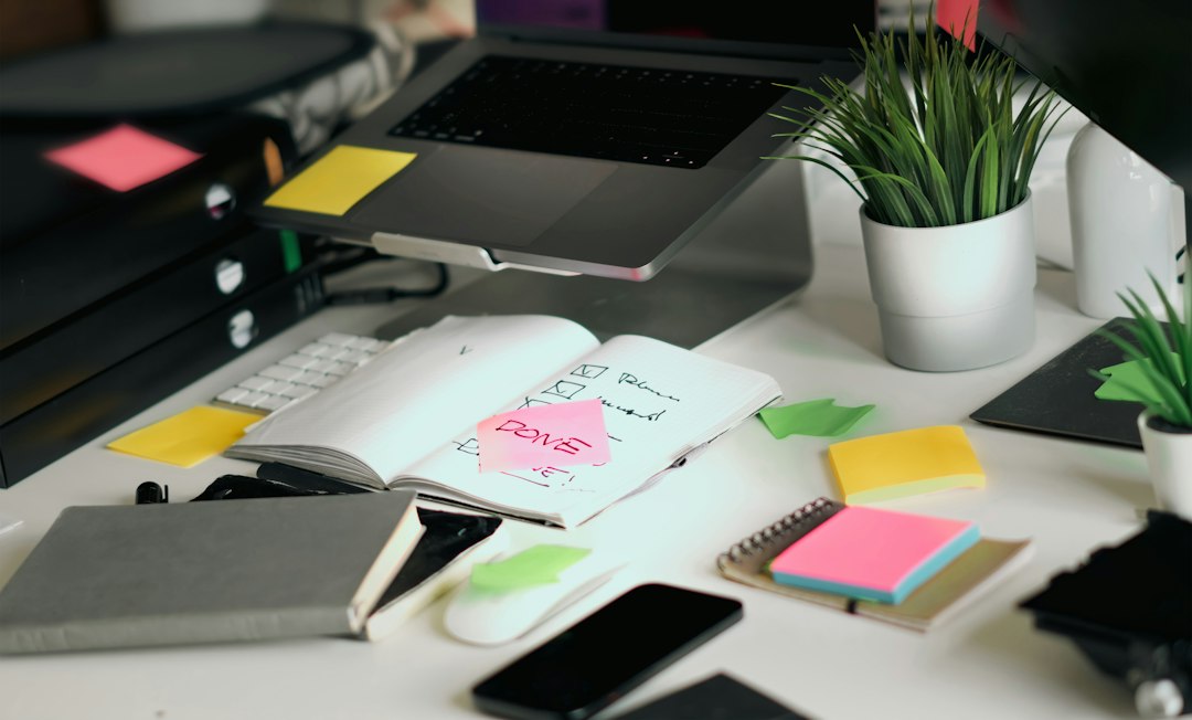 Organized workspace with notebook, laptop, phone and task notes representing mental clarity and focus